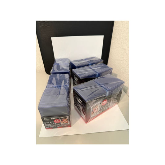five boxes of 100 count Ultra Pro card sleeves on a white background